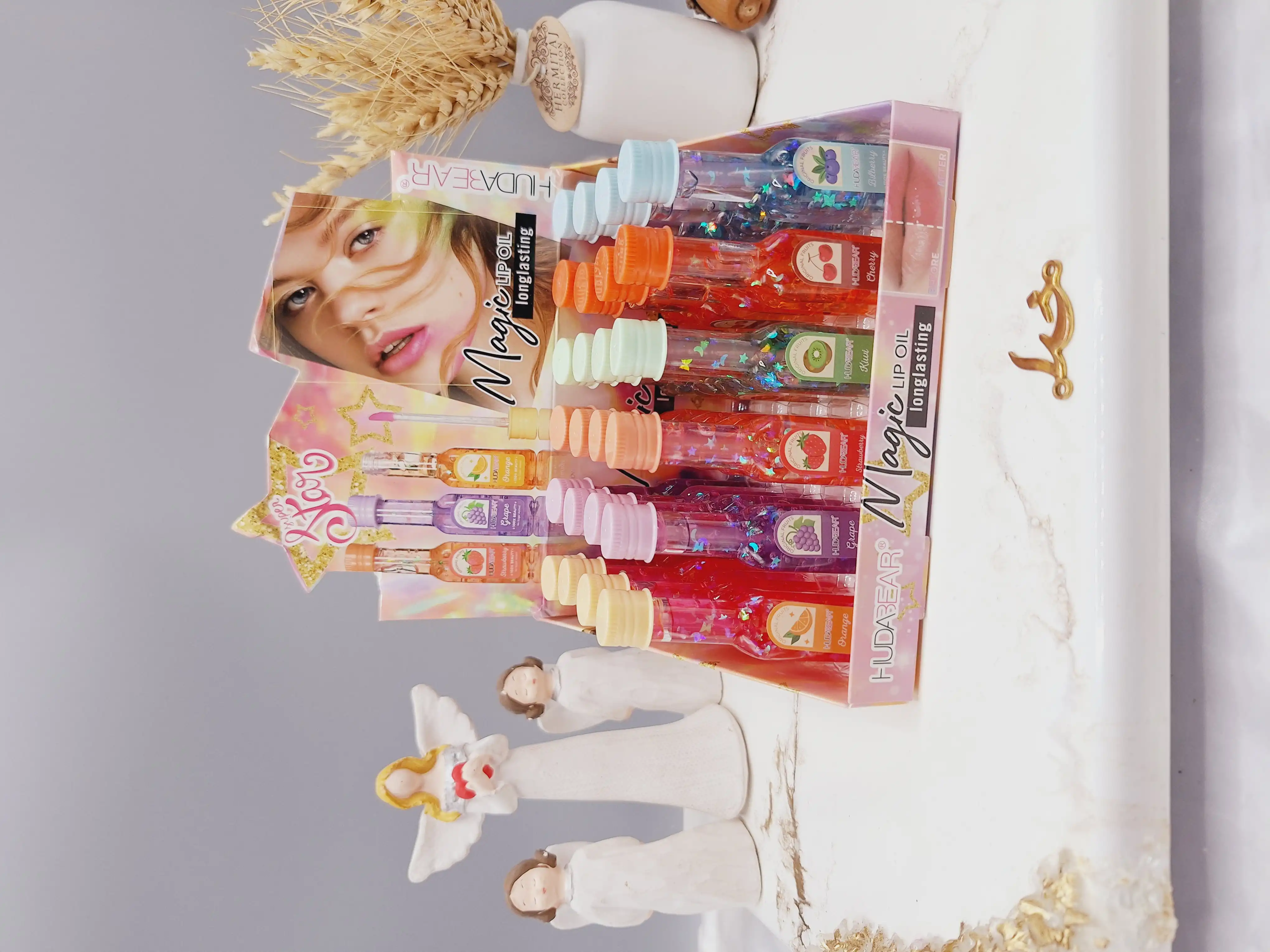 لیپ گلاس شاین دار طرح بطری شامپاین برند هدا بر HUDA BEAR کد M031