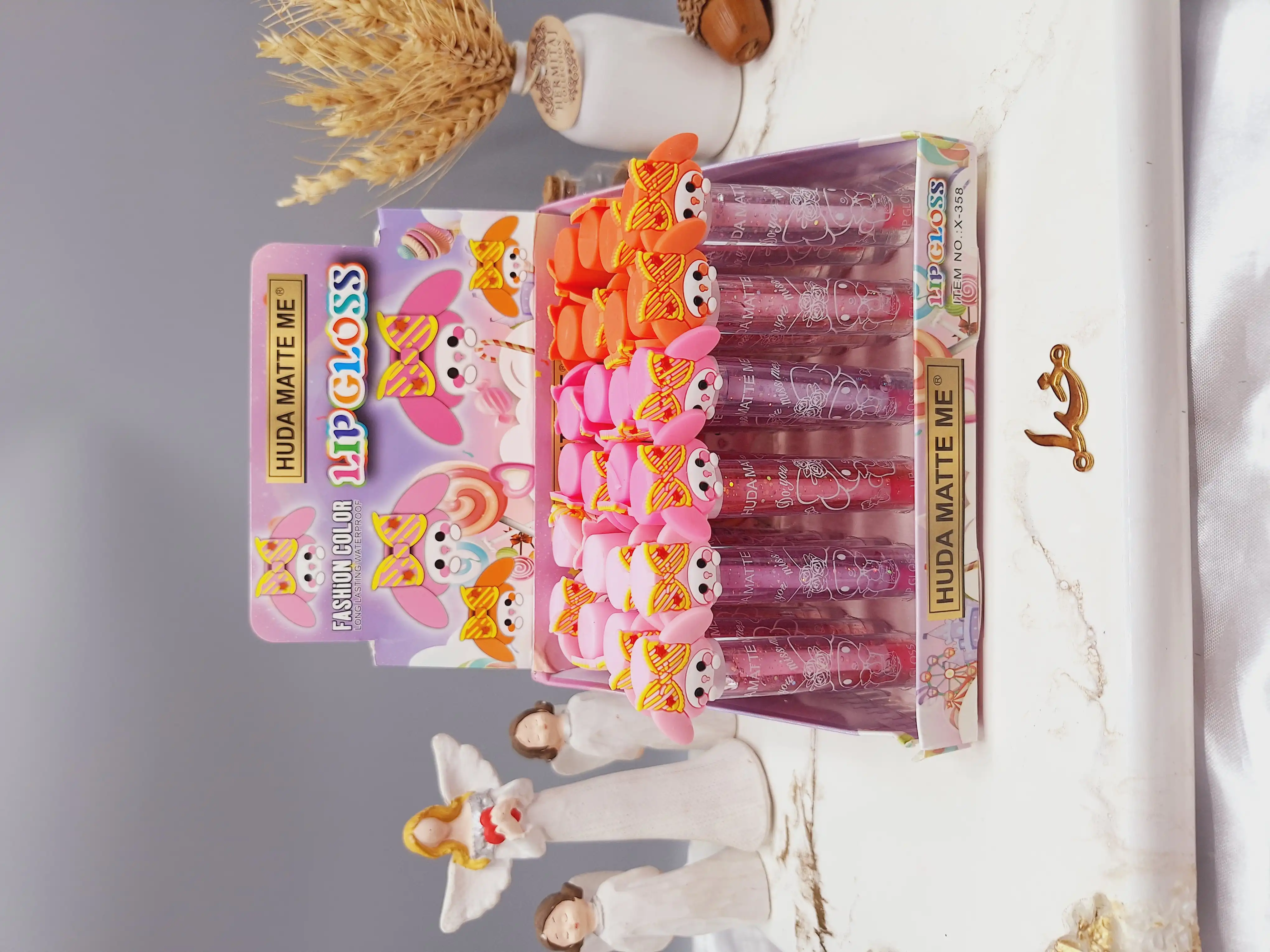 لیپ گلاس شاین دار  طرح فانتزی برند هدا مات می HUDA MATTE ME کد X-358