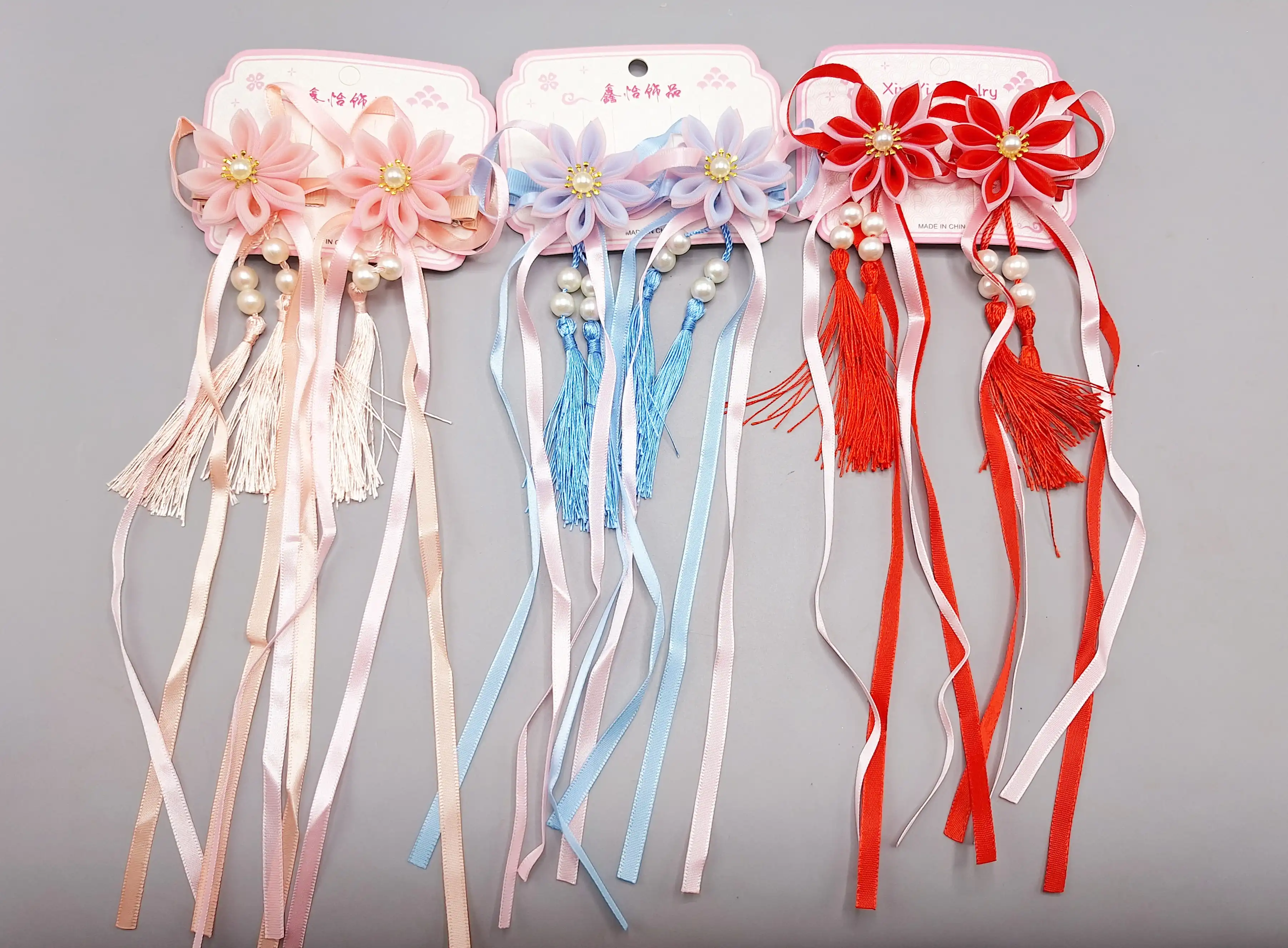 ست 2 تایی گیره مو طرح گل زیبا همراه با آویز نواری و نگین دار