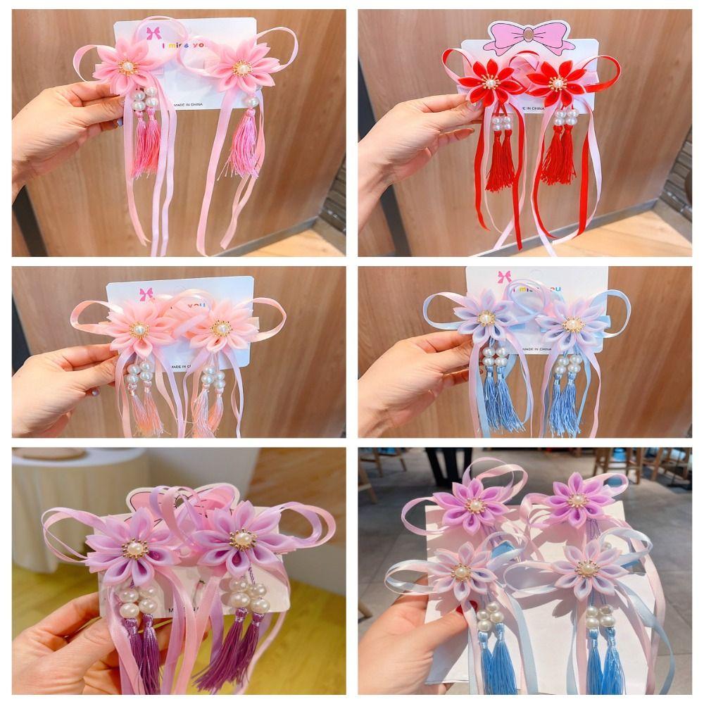 ست 2 تایی گیره مو طرح گل زیبا همراه با آویز نواری و نگین دار