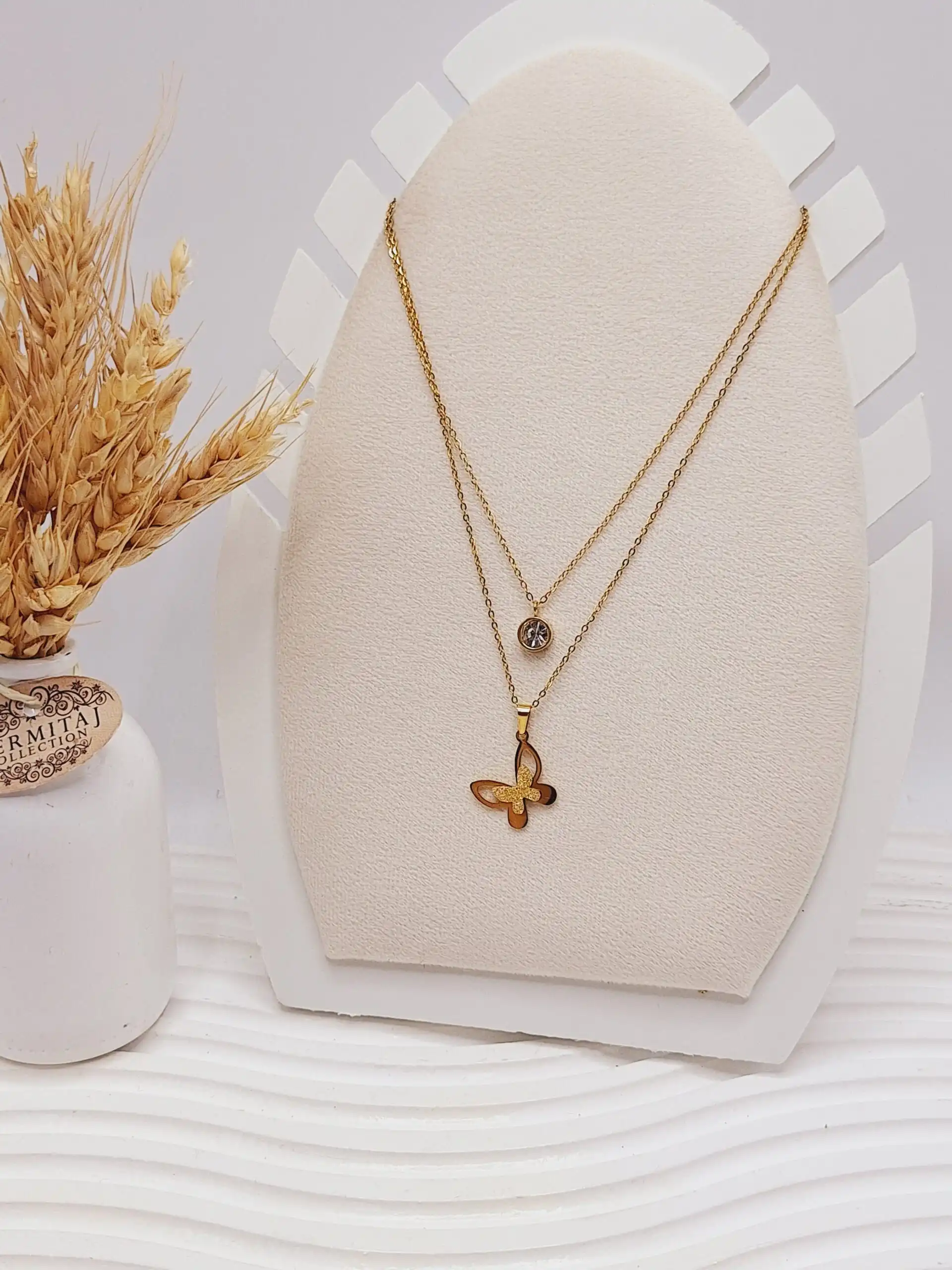 ست گوشواره و گردنبند دو لاین پروانه و آویز نگین دار رنگ طلایی استیل