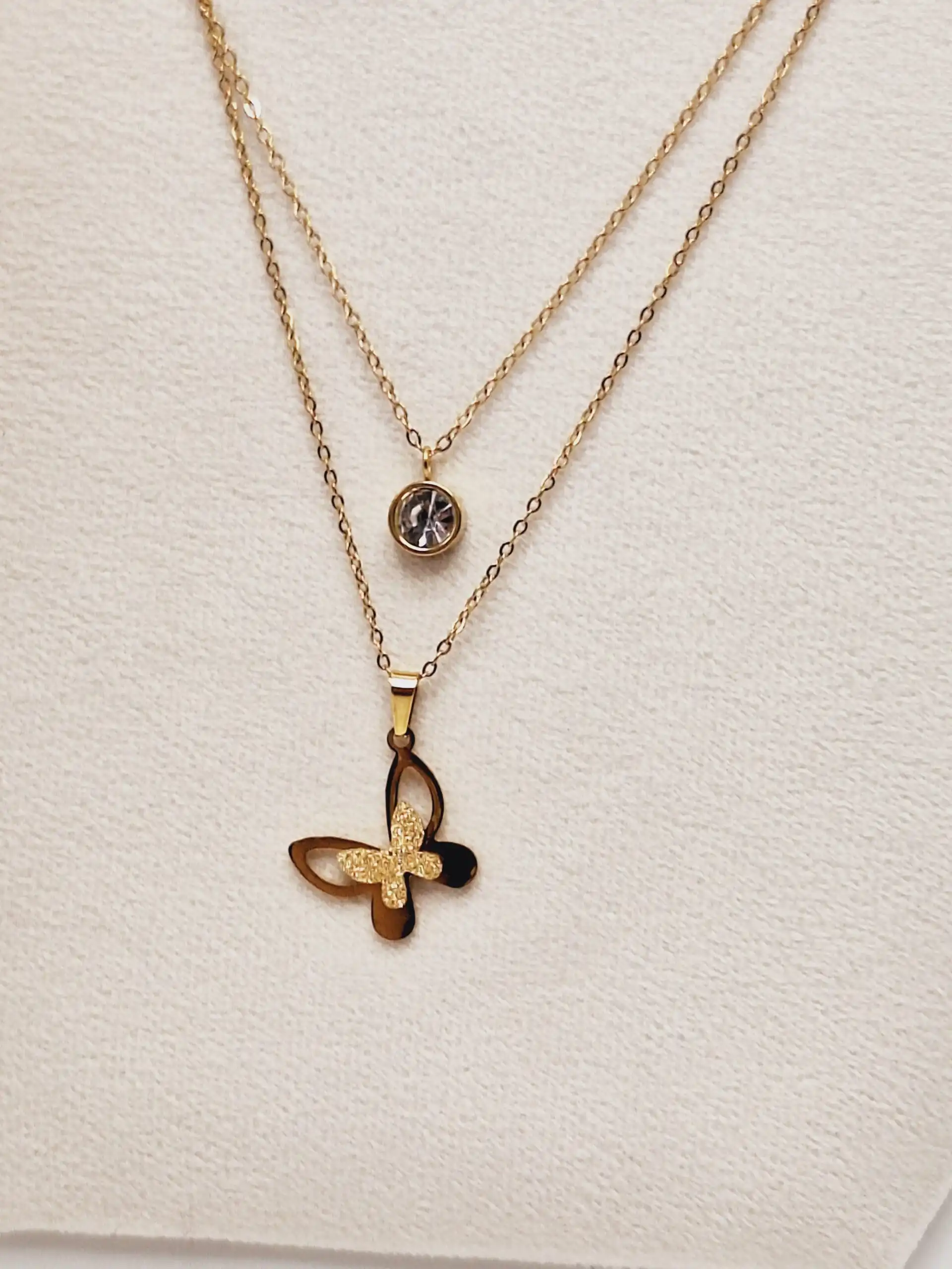 ست گوشواره و گردنبند دو لاین پروانه و آویز نگین دار رنگ طلایی استیل