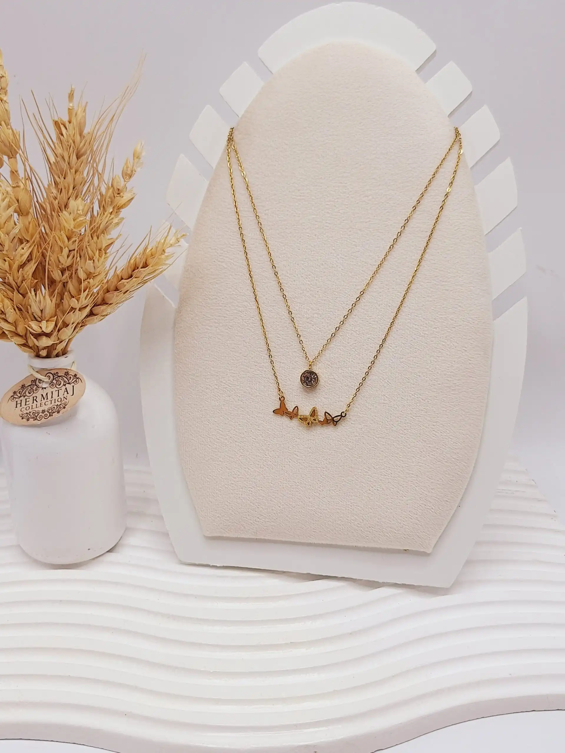 ست گوشواره و گردنبند دو لاین پروانه های ریز و آویز نگین دار رنگ طلایی استیل