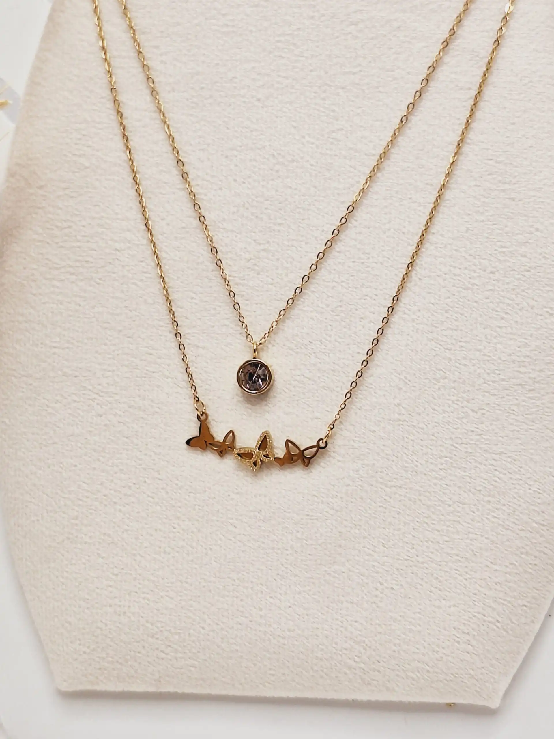 ست گوشواره و گردنبند دو لاین پروانه های ریز و آویز نگین دار رنگ طلایی استیل